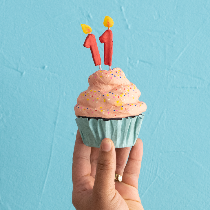 Hand holidng Creativebug's 11th Birthday Cupcakes, Paper Mache Cupcakes with Candles