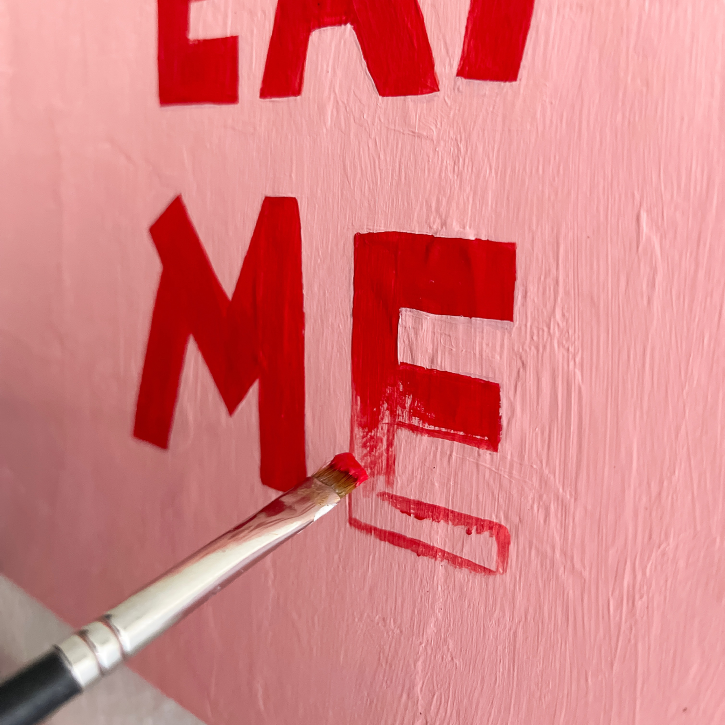 Paper Mache Crow Painting a Canvas That Says Don't Eat Me, Lettering Detail